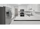 Modern kitchen features stainless steel appliances, white cabinetry, and plenty of counter space at 4274 Timber Trace Road, Loganville, GA 30052