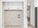 Laundry room featuring tile floor, white cabinetry, and washer/dryer hookups at 4274 Timber Trace Road, Loganville, GA 30052