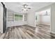 Bright living room with built-in shelves, wood flooring, open to the dining room at 4274 Timber Trace Road, Loganville, GA 30052