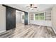 Stylish living room featuring wood floors, barn door, built-in shelving and window at 4274 Timber Trace Road, Loganville, GA 30052