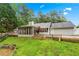 Charming rear exterior with screened porch, deck, patio, and landscaped yard on a well-maintained lawn at 4274 Timber Trace Road, Loganville, GA 30052