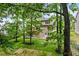 Rear view of the home featuring a wooden deck, patio, and well-maintained backyard at 1897 Alcovy Trace Way Way, Lawrenceville, GA 30045