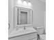 Bathroom features a white vanity, modern faucet, and a framed mirror at 1897 Alcovy Trace Way Way, Lawrenceville, GA 30045
