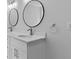 Bathroom with dual sinks, round mirrors, and modern fixtures at 1897 Alcovy Trace Way Way, Lawrenceville, GA 30045