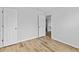 A bedroom featuring wood-look flooring, neutral walls, and an open doorway at 1897 Alcovy Trace Way Way, Lawrenceville, GA 30045
