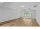 Spacious bedroom with large window offering natural light and modern tray ceiling with fan at 1897 Alcovy Trace Way Way, Lawrenceville, GA 30045