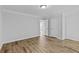 Neutral bedroom showcasing hardwood flooring, complemented by two doors and a seamless, modern aesthetic at 1897 Alcovy Trace Way Way, Lawrenceville, GA 30045