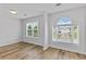 Bedroom with two windows offering a clear view of the neighborhood and wood-look flooring at 1897 Alcovy Trace Way Way, Lawrenceville, GA 30045