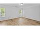 Bright bedroom with hardwood floors, large windows, allowing natural light; fresh, modern feel at 1897 Alcovy Trace Way Way, Lawrenceville, GA 30045