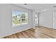 The bedroom showcases windows, wood-look floors, a door, and a neutral color scheme at 1897 Alcovy Trace Way Way, Lawrenceville, GA 30045