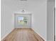 A cozy room offers natural light through its window and light colored hardwood floors at 1897 Alcovy Trace Way Way, Lawrenceville, GA 30045