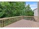 An outdoor wooden deck with railing offers a serene view of surrounding greenery at 1897 Alcovy Trace Way Way, Lawrenceville, GA 30045