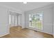Bright dining room with hardwood floors, wainscoting, and a large window at 1897 Alcovy Trace Way Way, Lawrenceville, GA 30045
