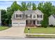 Traditional two-story home featuring a well-maintained front lawn and a double-car garage at 1897 Alcovy Trace Way Way, Lawrenceville, GA 30045