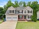 Charming two-story home featuring a two-car garage and well-manicured front lawn at 1897 Alcovy Trace Way Way, Lawrenceville, GA 30045