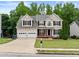 Beautiful two-story home with lush green lawn, attached two-car garage, and inviting entryway at 1897 Alcovy Trace Way Way, Lawrenceville, GA 30045