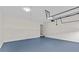 Spacious garage with blue flooring and an overhead garage door mechanism at 1897 Alcovy Trace Way Way, Lawrenceville, GA 30045