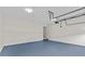Spacious garage showcasing ample room for vehicles and storage with blue floor and natural lighting at 1897 Alcovy Trace Way Way, Lawrenceville, GA 30045