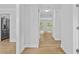Bright hallway features hardwood floors, white trim and leads to a view of a sunlit room at 1897 Alcovy Trace Way Way, Lawrenceville, GA 30045