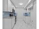 Bright kitchen featuring white cabinets, stainless steel appliances and light blue backsplash at 1897 Alcovy Trace Way Way, Lawrenceville, GA 30045