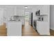 Bright kitchen with white cabinets, stainless steel appliances, and hardwood floors at 1897 Alcovy Trace Way Way, Lawrenceville, GA 30045