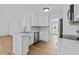 Bright kitchen featuring white cabinets, stainless steel appliances, and a modern countertop at 1897 Alcovy Trace Way Way, Lawrenceville, GA 30045
