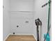 Bright laundry area features a wire shelf and wood-look flooring at 1897 Alcovy Trace Way Way, Lawrenceville, GA 30045