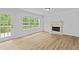Living room with a fireplace, hardwood floors, and large window at 1897 Alcovy Trace Way Way, Lawrenceville, GA 30045