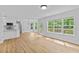 Spacious living area with a modern chandelier, large windows, and an adjacent kitchen at 1897 Alcovy Trace Way Way, Lawrenceville, GA 30045