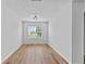 Well-lit room with wood floors, neutral walls, and a view from the large window at 1897 Alcovy Trace Way Way, Lawrenceville, GA 30045