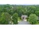 Overhead shot of the home with a well-manicured lawn, surrounded by dense trees at 2701 Windsor Nw Ct, Kennesaw, GA 30144