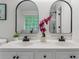 Stylish bathroom featuring double sinks, modern black fixtures, and a view of the shower at 2701 Windsor Nw Ct, Kennesaw, GA 30144