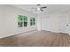 Spacious room with vinyl floors, a ceiling fan, and double windows overlooking the backyard at 2701 Windsor Nw Ct, Kennesaw, GA 30144
