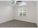 This bedroom features neutral walls, carpet flooring, and a ceiling fan for added comfort at 2701 Windsor Nw Ct, Kennesaw, GA 30144