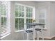 Cozy breakfast nook with natural light from surrounding windows and seating for two at 2701 Windsor Nw Ct, Kennesaw, GA 30144