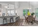 Bright dining area with modern lighting and a clear view of the adjacent kitchen and bar seating at 2701 Windsor Nw Ct, Kennesaw, GA 30144
