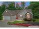 Charming ranch-style home featuring stone accents, a well-manicured lawn, and an attached two-car garage at 2701 Windsor Nw Ct, Kennesaw, GA 30144