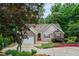 A charming house with stone accents, a two-car garage, and mature trees in the front yard at 2701 Windsor Nw Ct, Kennesaw, GA 30144