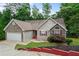 Charming one-story home featuring stone accents, a two-car garage, and mature landscaping at 2701 Windsor Nw Ct, Kennesaw, GA 30144