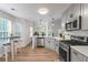 Modern kitchen with stainless steel appliances, gray cabinets, and hardwood floors at 2701 Windsor Nw Ct, Kennesaw, GA 30144