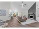 Open-concept living room with modern decor, hardwood floors, and a striking fireplace at 2701 Windsor Nw Ct, Kennesaw, GA 30144