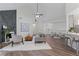 Spacious living area with a modern fireplace, wood flooring, and an open layout to the kitchen and dining area at 2701 Windsor Nw Ct, Kennesaw, GA 30144