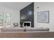Comfortable living room featuring a sleek fireplace, neutral furnishings, and sliding glass doors to the outdoor deck at 2701 Windsor Nw Ct, Kennesaw, GA 30144