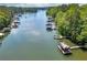 Aerial view of the lake, highlighting numerous docks and boat houses, surrounded by lush greenery at 2825 Lake Ct, Cumming, GA 30041