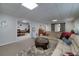 Basement living space with comfortable seating and a pool table room accessible through an archway at 2825 Lake Ct, Cumming, GA 30041