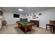 Finished basement with a pool table, bar stools, bench seating and carpeted floors at 2825 Lake Ct, Cumming, GA 30041