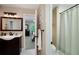 Neutral toned bathroom with large vanity mirror and combination tub and shower at 2825 Lake Ct, Cumming, GA 30041