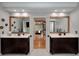Bathroom with dual sink vanity and wooden framed mirrors at 2825 Lake Ct, Cumming, GA 30041