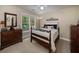 Cozy bedroom with dark wood furnishings and natural light at 2825 Lake Ct, Cumming, GA 30041