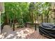 Back deck with cable railings overlooking a lush green backyard with mature trees and grill at 2825 Lake Ct, Cumming, GA 30041
